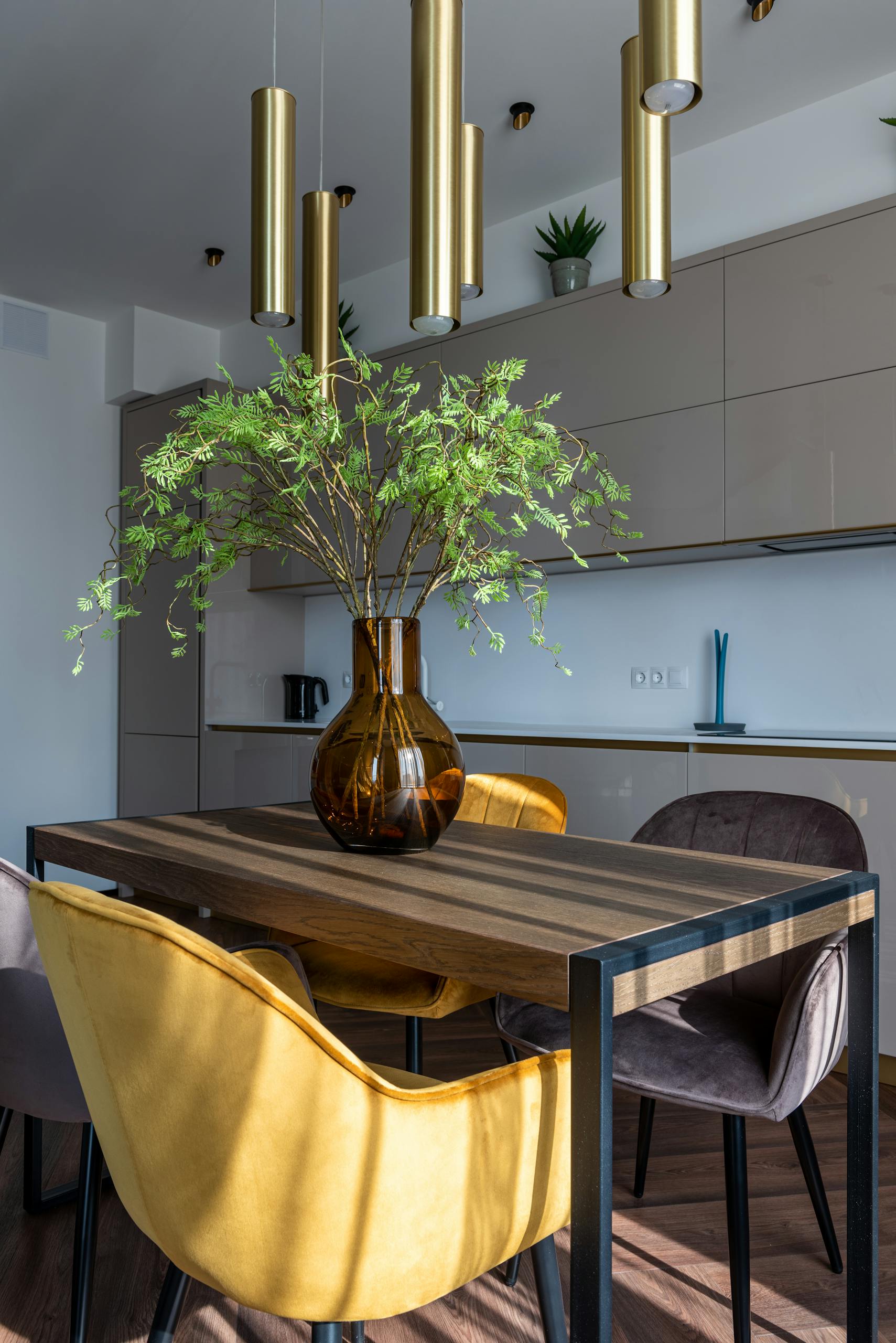 Stylish dining area with modern furniture and fresh greenery creating a cozy ambiance.